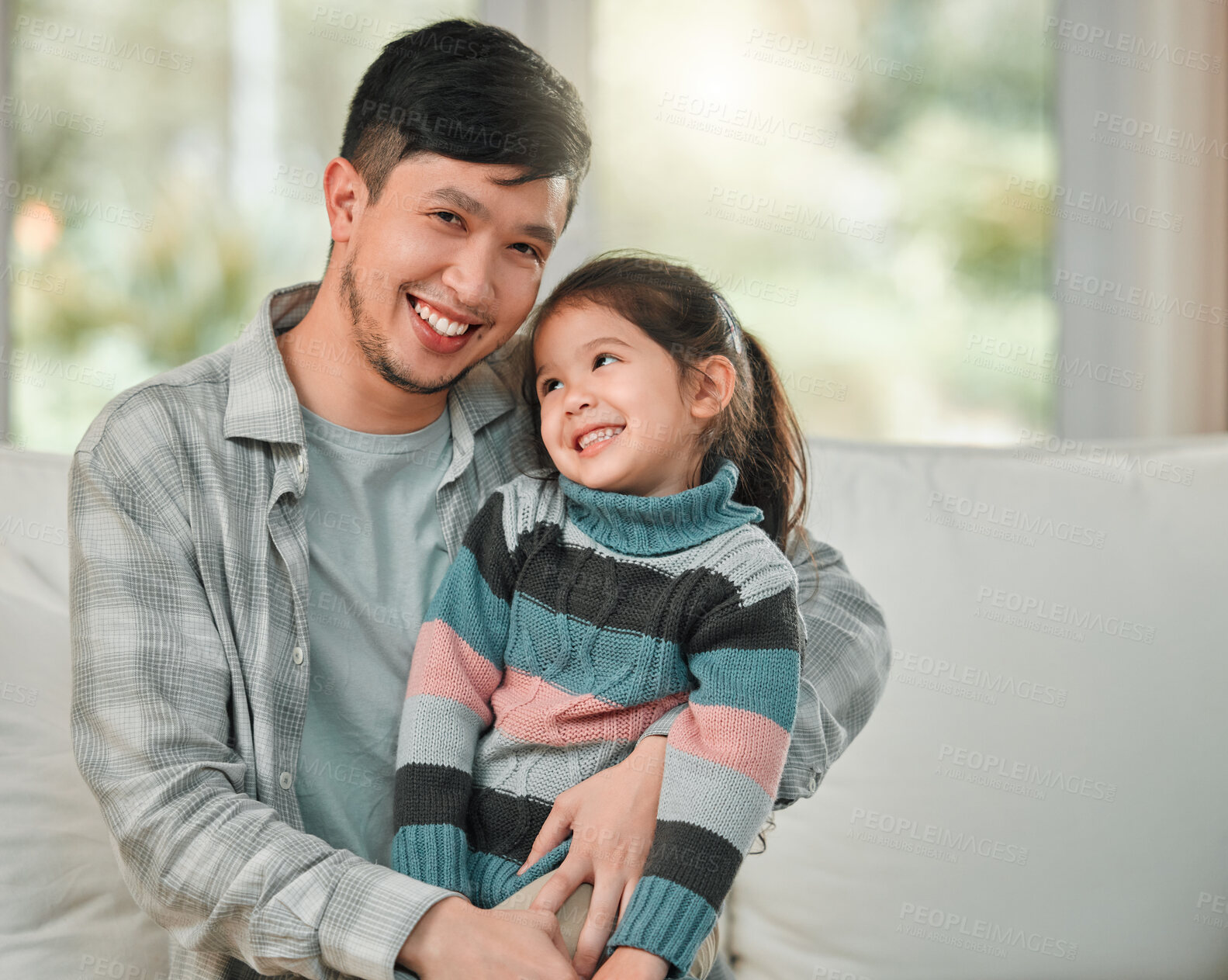 Buy stock photo Portrait of a young father and daughter bonding on the sofa at home
