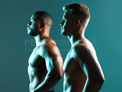 Buy stock photo Studio shot of two handsome and muscular young men posing against a green background