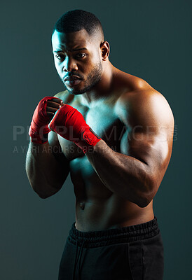 Buy stock photo Shot of a handsome young man boxing against a studio background