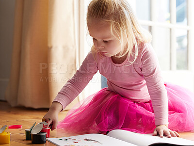 Buy stock photo Shot of a little girl doing a finger painting at home
