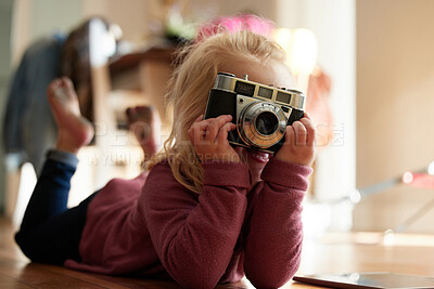 Buy stock photo Shot of a little girl taking a picture with a camera
