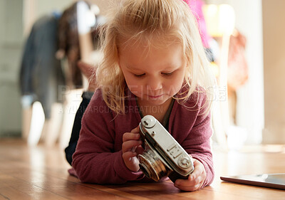 Buy stock photo Shot of an adorable little girl playing with a camera