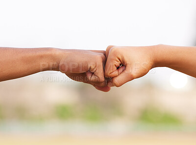 Buy stock photo Shot of two people fist bumping during a workout