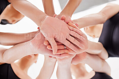 Buy stock photo Shot of a group of ballet dancers with their hands stacked