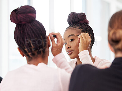 Buy stock photo Shot of a young ballerina applying cosmetic products onto her eyebrows
