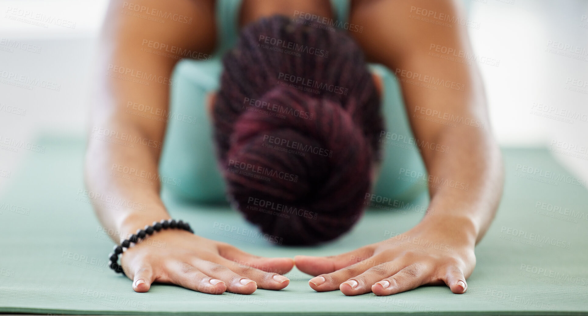 Buy stock photo Shot of an unrecognisable woman practising yoga in the studio and holding a child's pose