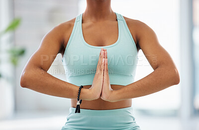 Buy stock photo Cropped shot of an unrecognisable woman meditating alone on a yoga studio
