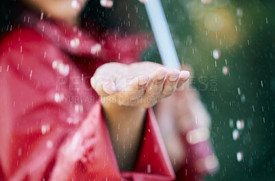Buy stock photo Closeup shot of an unrecognisable woman standing in the rain with an umbrella