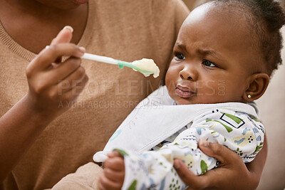 Buy stock photo Shot of an unrecognizable mother feeding her baby at home