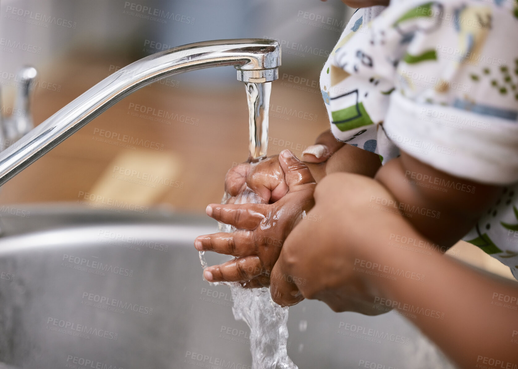 Buy stock photo Shot of an unrecognizable child and parent washing their hands at home