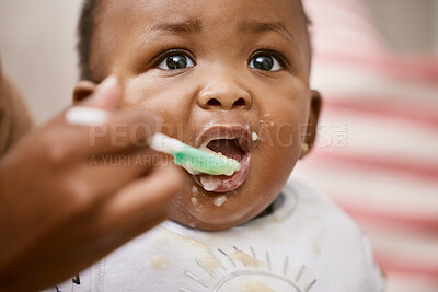 Buy stock photo Shot of an unrecognizable mother feeding her baby at home