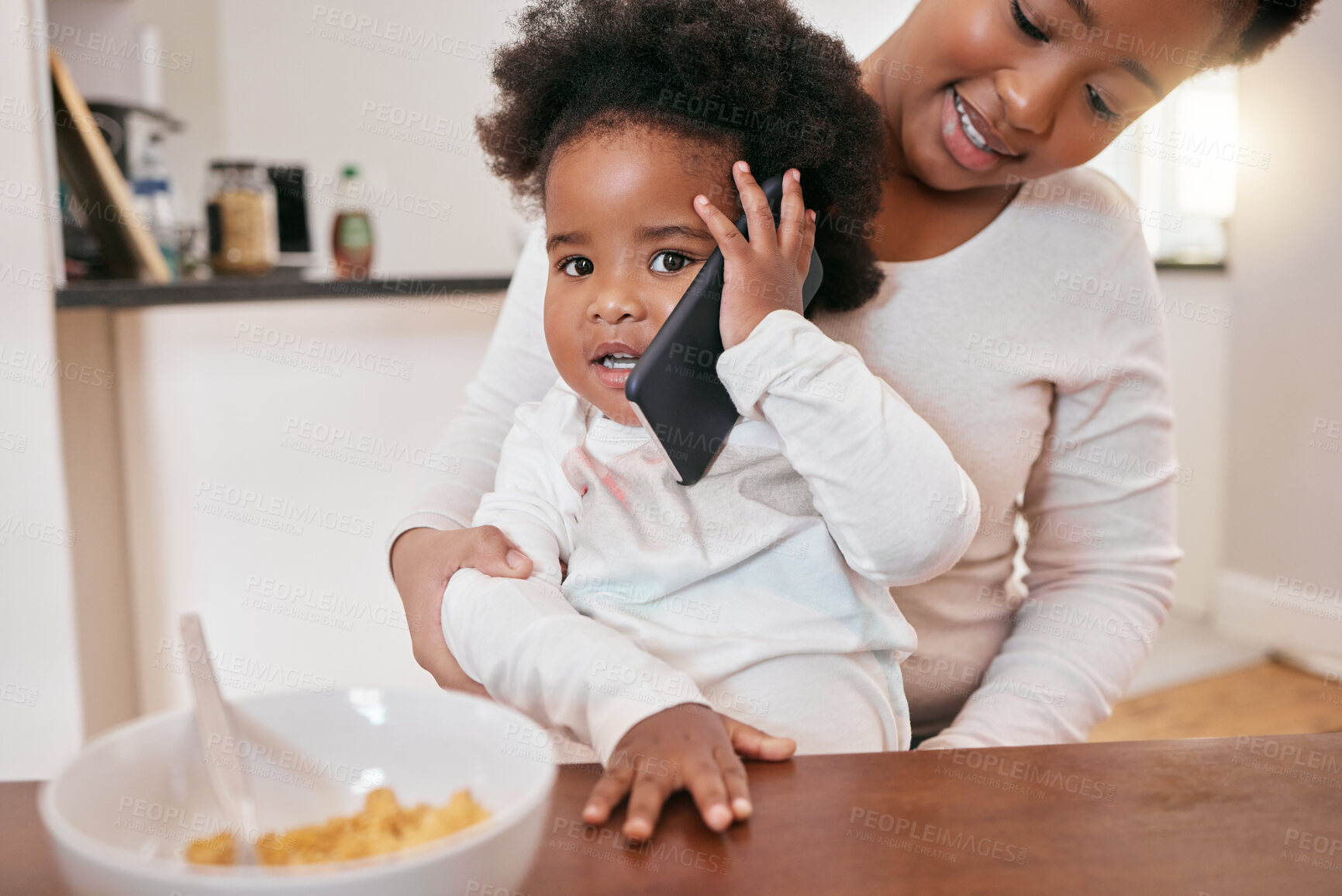 Buy stock photo Shot of a little baby girl playing with her mothers smartphone