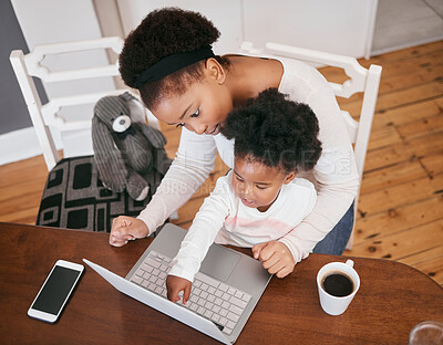 Buy stock photo Shot of a little girl playing on her mothers laptop