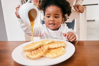 Buy stock photo Shot of a little girl pouring honey over some waffles