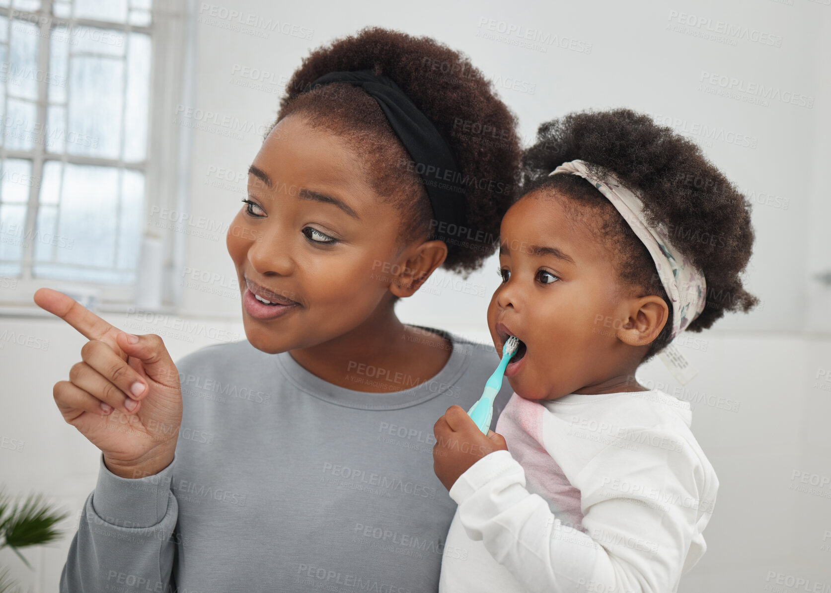 Buy stock photo Mother, toddler and washing of teeth, bathroom and helping of baby with hygiene, smile and black family. House, pointing and woman with child with brush, happiness and oral health of daughter