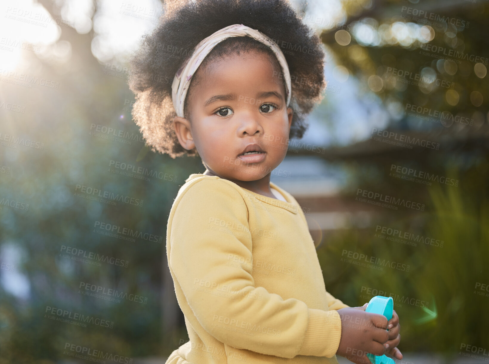 Buy stock photo Shot of a little girl playing in a garden