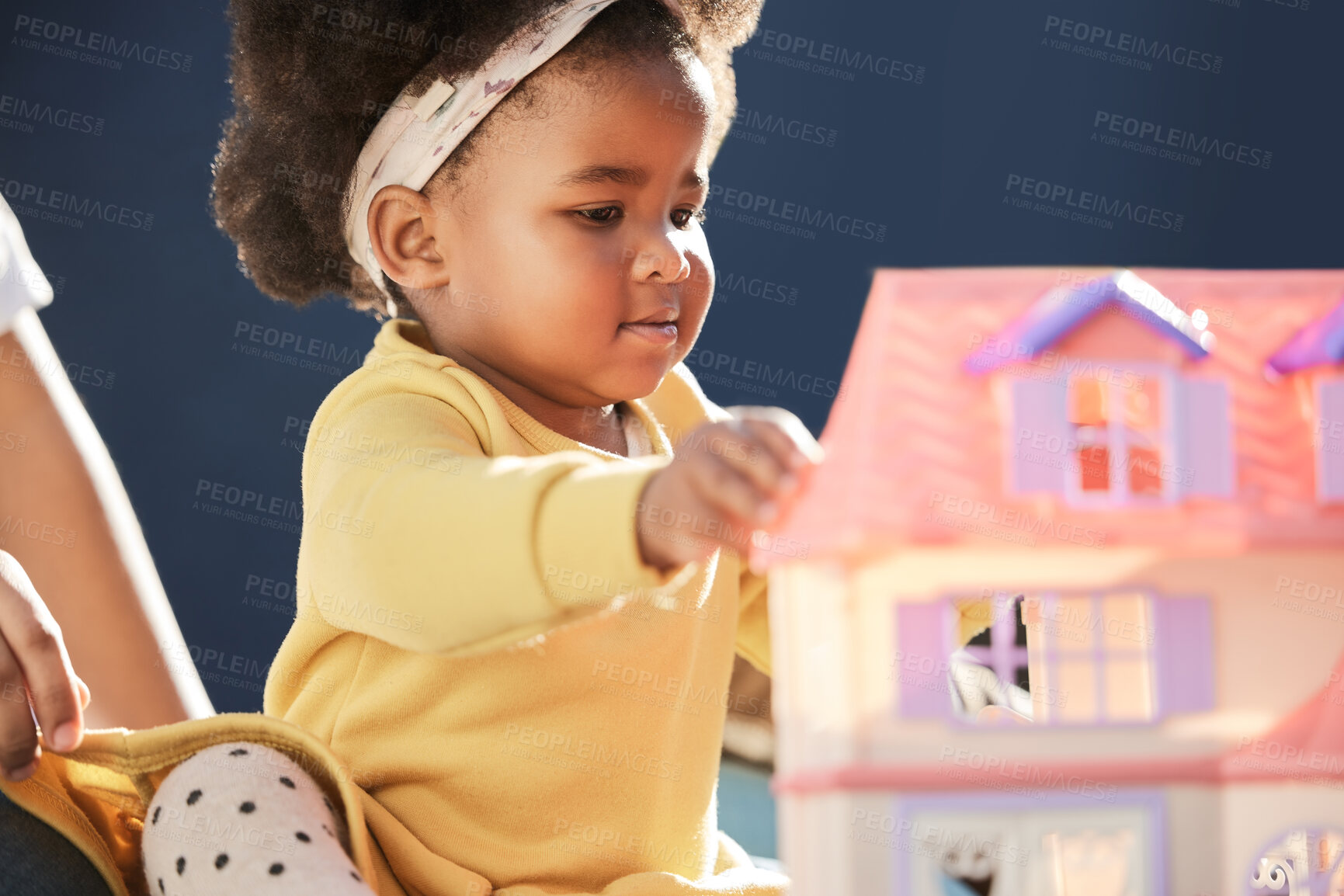 Buy stock photo Child development, dollhouse and girl having fun with toy in nursery of home for future or growth. Floor, learning and motor skills with African kid in playroom of apartment for game, baby or leisure