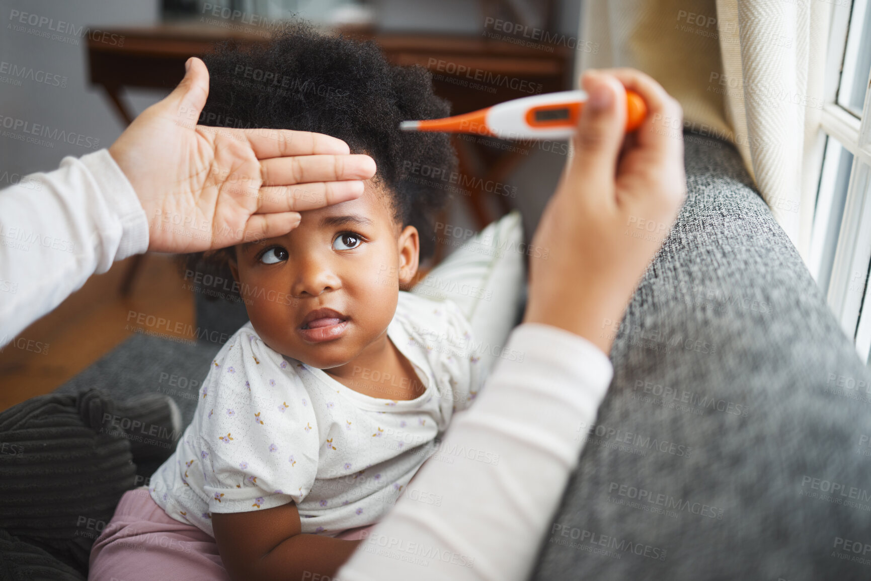 Buy stock photo Shot of an unrecognizable mother checking her daughter's temperature at home