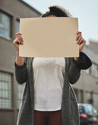 Buy stock photo Cropped shot of an unrecognizable woman holding a sign while protesting for her rights