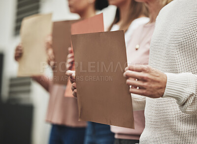 Buy stock photo Cropped shot of a group of unrecognizable people holding signs while taking part in a political rally