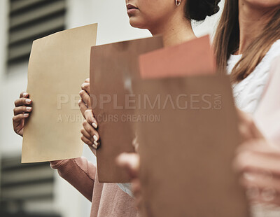 Buy stock photo Cropped shot of a group of unrecognizable people holding signs while taking part in a political rally