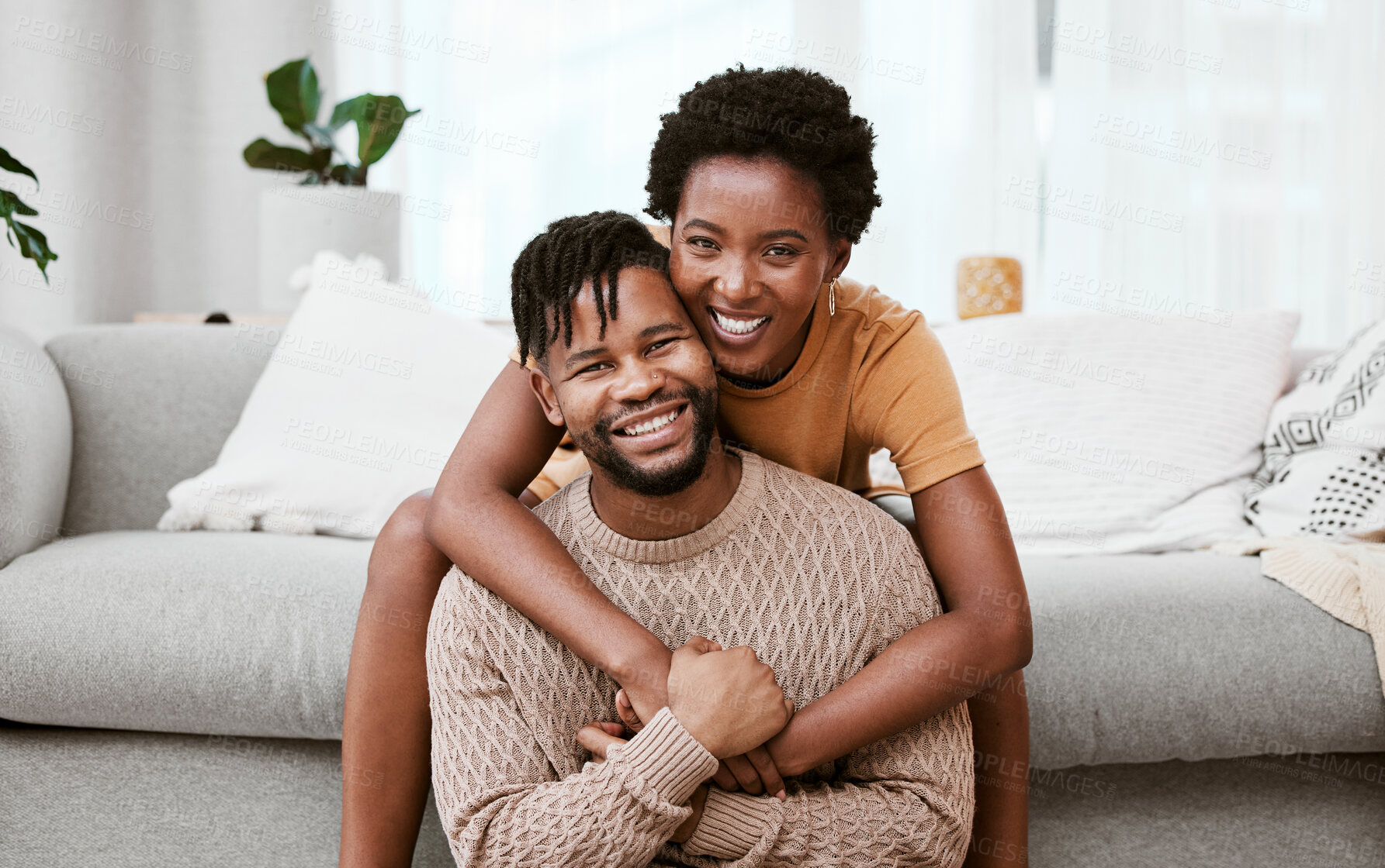 Buy stock photo Shot of a young couple relaxing at home