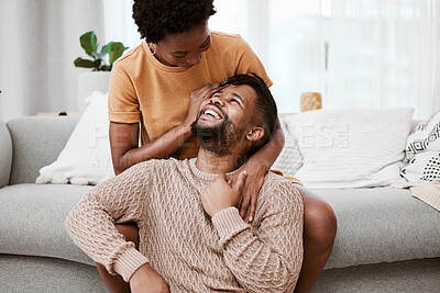 Buy stock photo Couple, black woman and man in living room, love and together for peace, smile and romance in home to relax. House, African person and partner in lounge, touch and happy for marriage and commitment