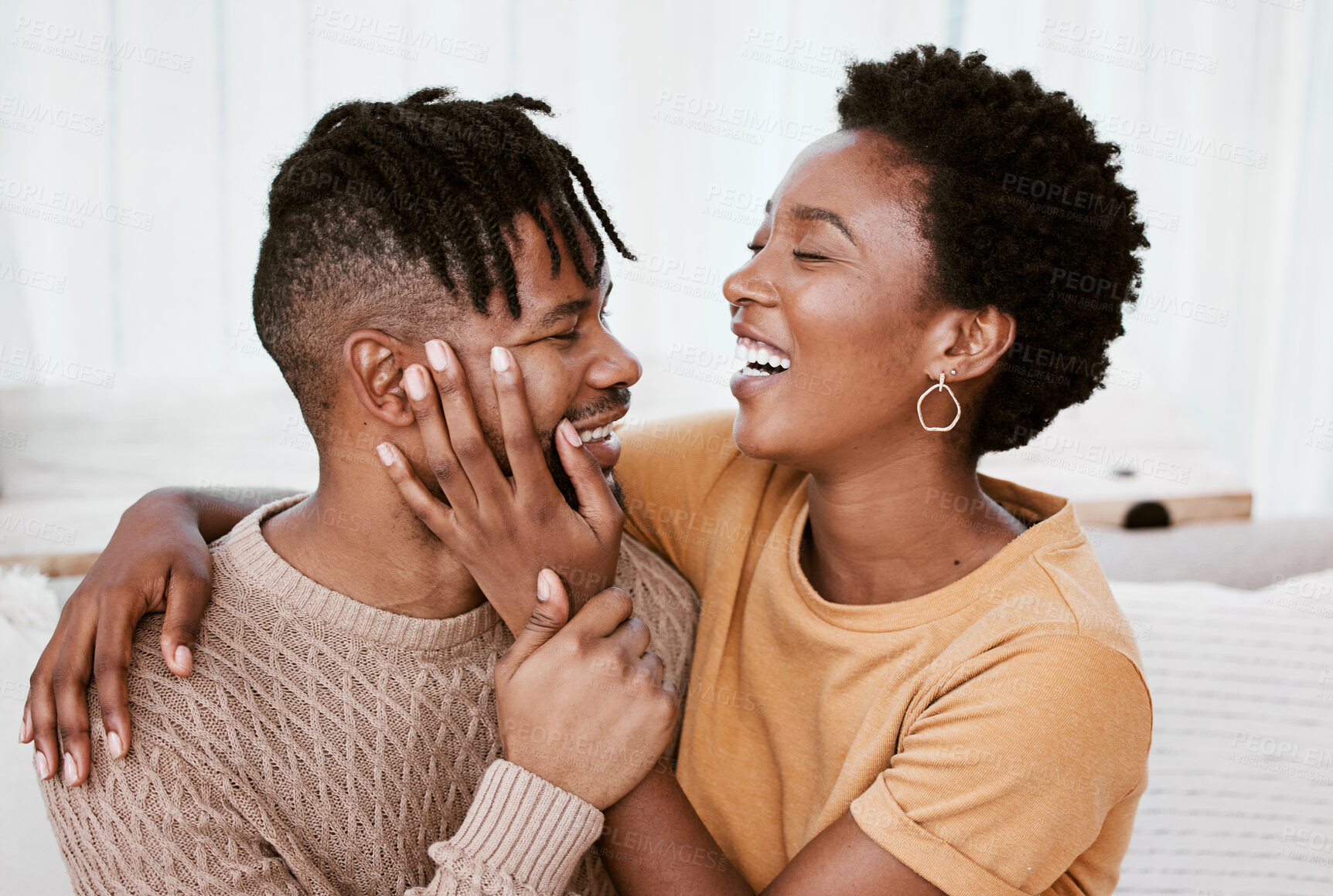 Buy stock photo Laughing, black couple and embrace in living room, man and woman with love, romance and relax in home for break. House, African person and partner in lounge, joke and happy for marriage or commitment