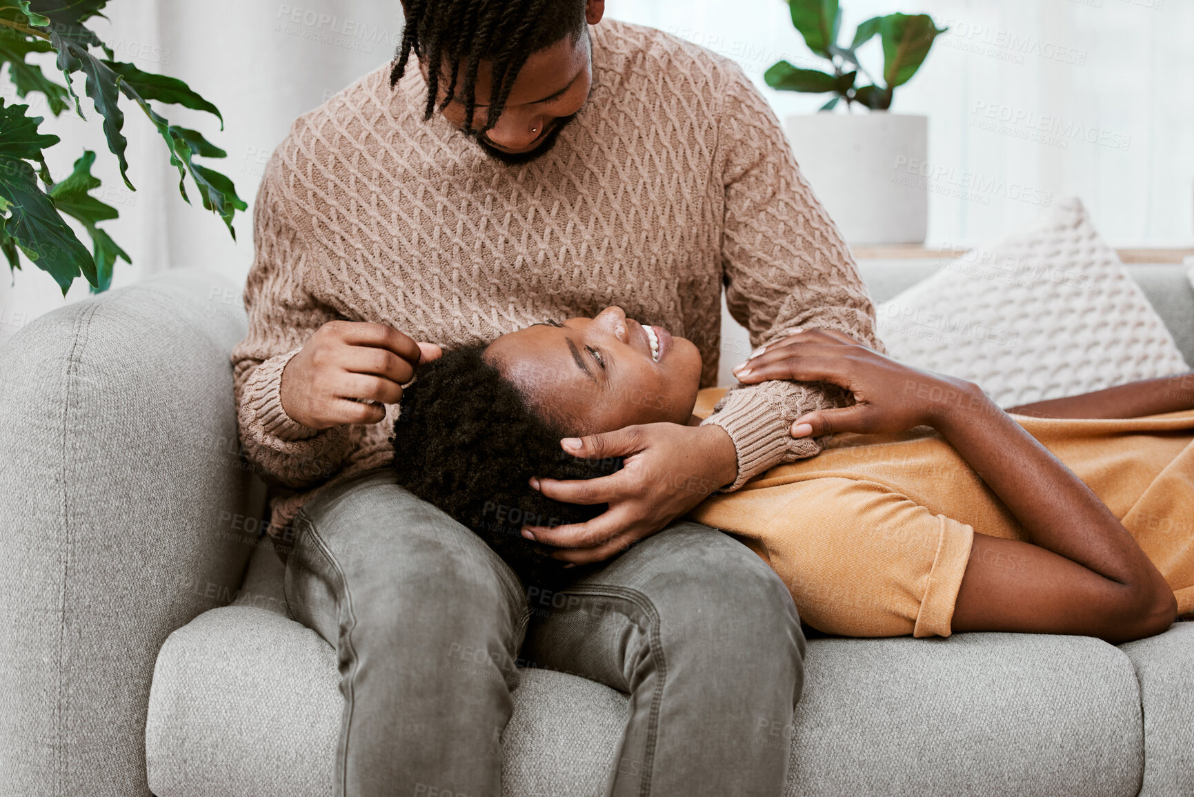 Buy stock photo Living room, black woman and lap of man, couple and love on couch, embrace or romance of relationship. Home, person and partner in lounge of apartment, relax and smile for rest, together and marriage