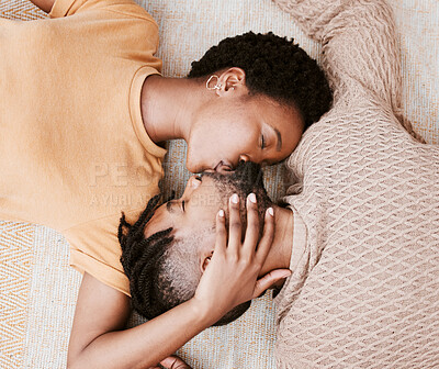 Buy stock photo Aerial shot of a young couple kissing at home