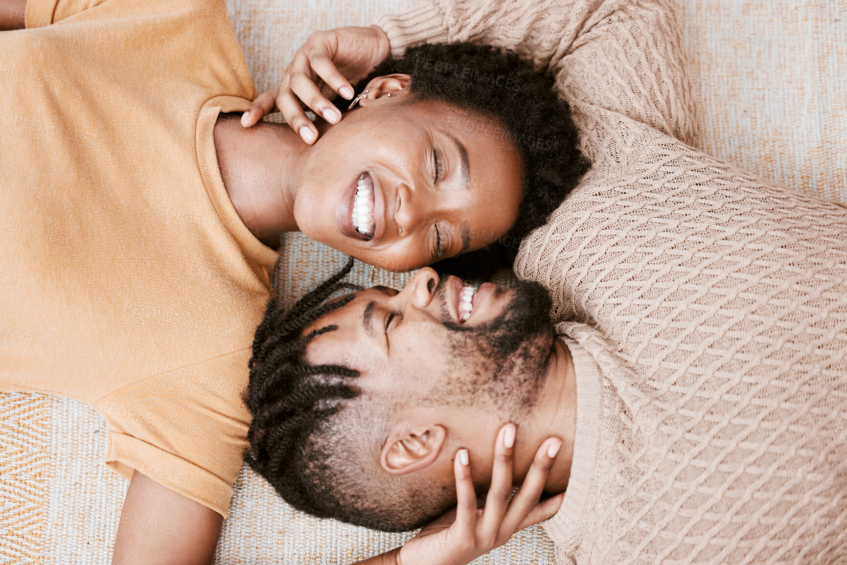 Buy stock photo Black couple, happy and floor for love in house, hand and woman together with man, smile and happiness. Home, person and partner with touch, above and relax on date, ground and rest in apartment