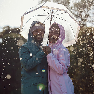 Buy stock photo Shot of an affectionate couple standing under an umbrella while out in the rain