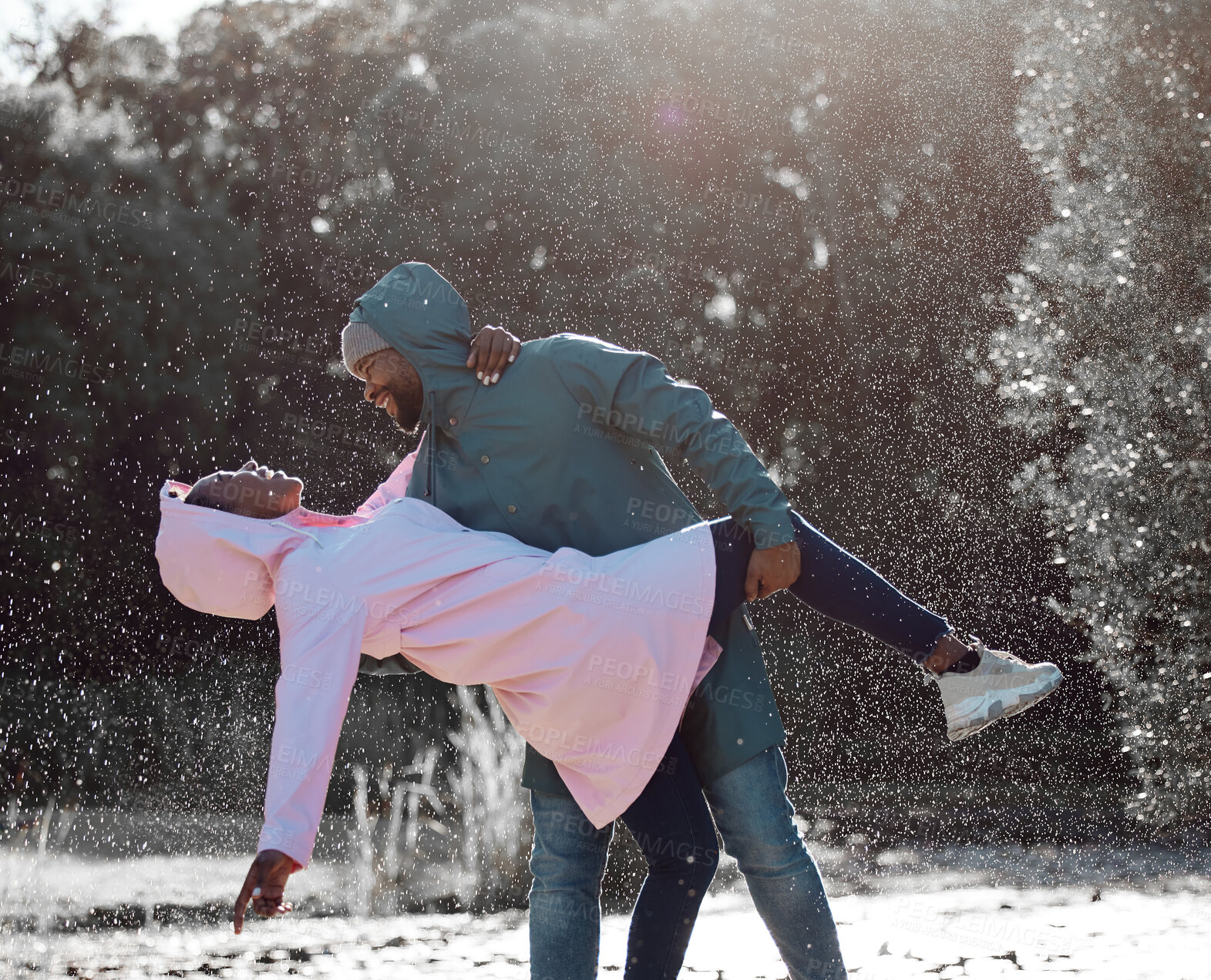 Buy stock photo Couple, dancing and happy or rain in countryside, park or camping in nature or forest for holiday, trip and fun adventure together. Man, woman or celebration for anniversary, relationship and romance