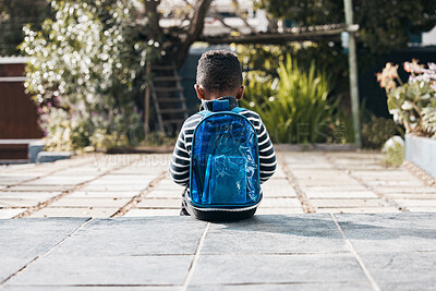 Buy stock photo Shot of a little boy sitting outside with his backpack