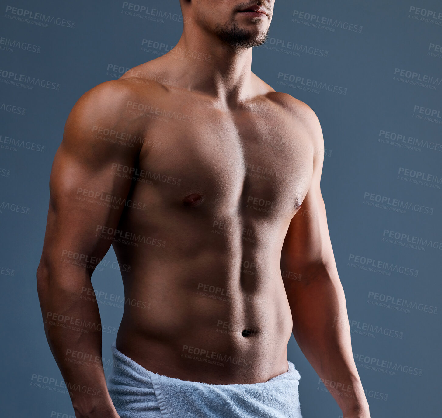 Buy stock photo Cropped shot of an unrecognizable man posing in a towel against a grey background