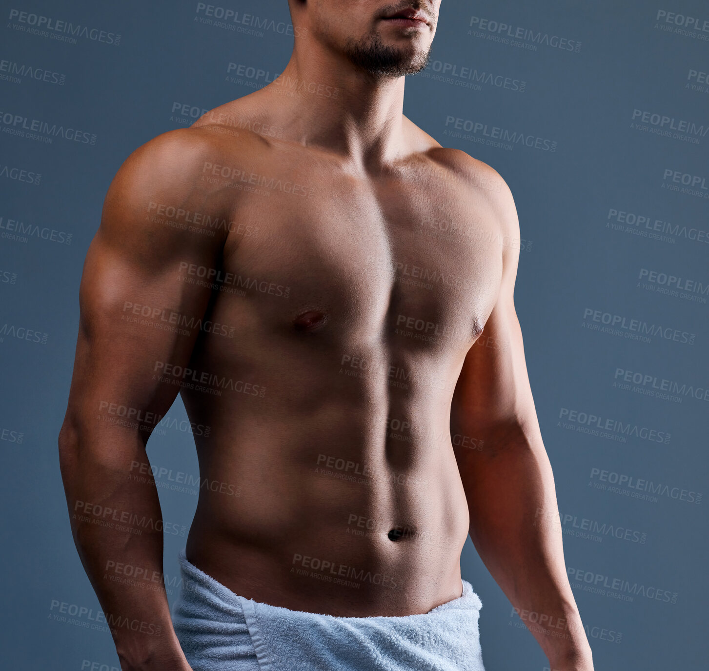 Buy stock photo Abs, towel and man in studio for fitness, body care and core muscle development on background. Bodybuilder, athletic person and strong chest with six pack growth, stomach and health for wellness