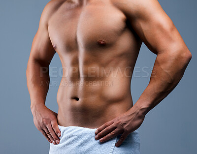 Buy stock photo Cropped shot of an unrecognizable man posing in a towel against a grey background