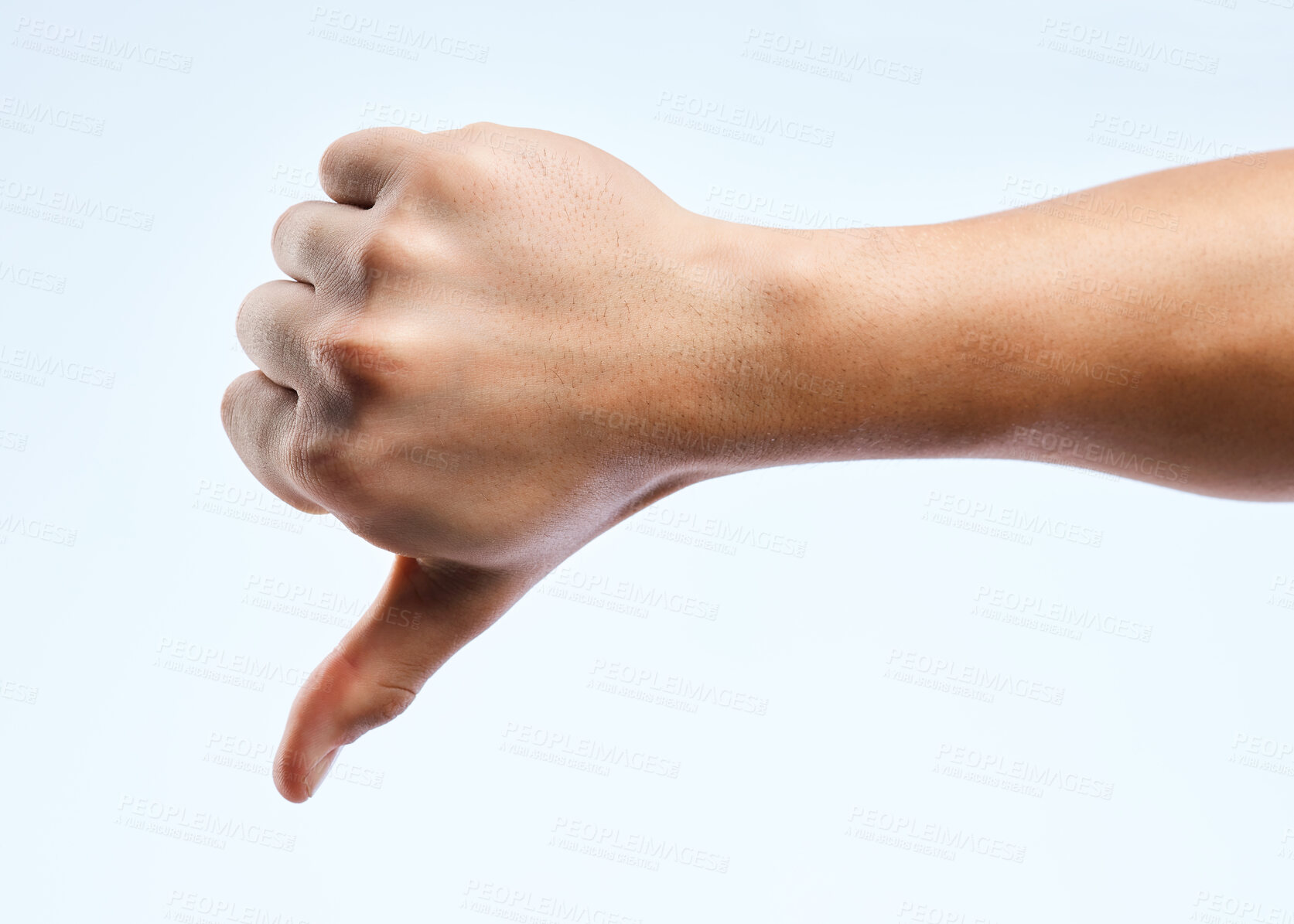 Buy stock photo Shot of an unrecognizable man holding out his hand showing the thumbs down against a white background