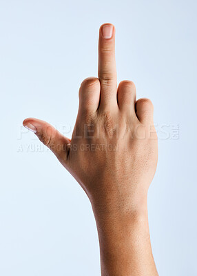 Buy stock photo Shot of an unrecognizable man holding out his hand showing the middle finger against a white background