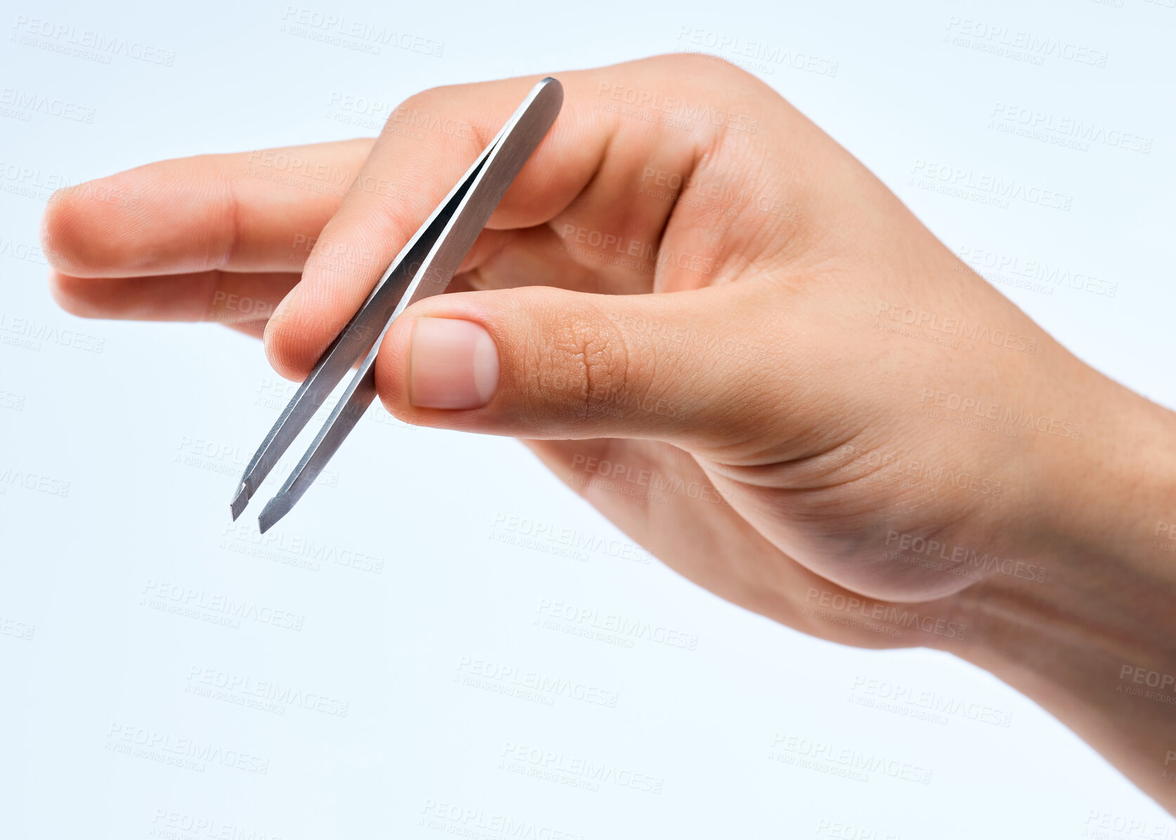 Buy stock photo Shot of an unrecognizable man holding a tweezer against a white background