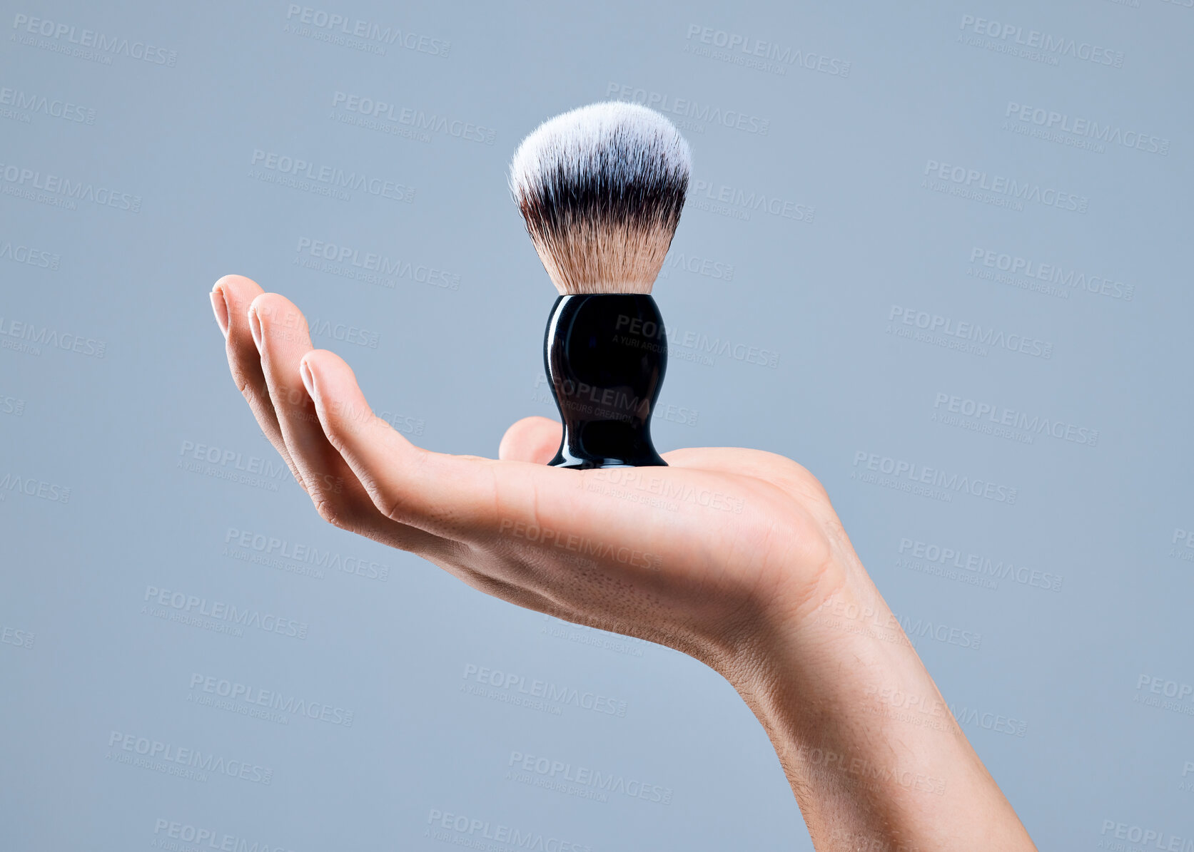 Buy stock photo Shot of an unrecognizable man holding a brush against a grey background