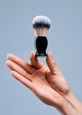 Buy stock photo Shot of an unrecognizable man holding a brush against a grey background