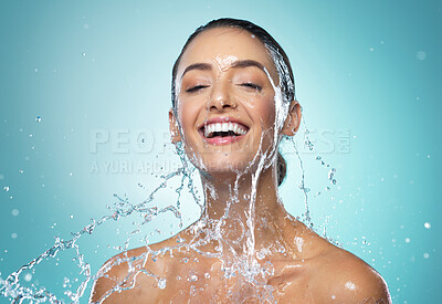 Buy stock photo Shot of a young woman washing her hair in the shower against a blue background