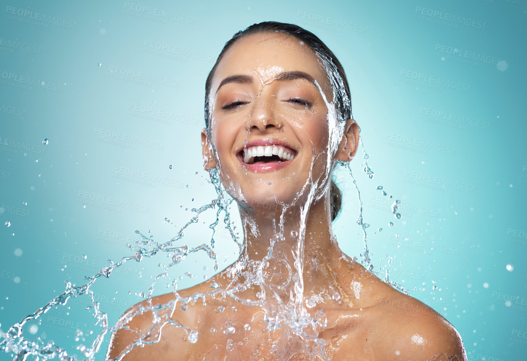 Buy stock photo Shot of a young woman washing her hair in the shower against a blue background