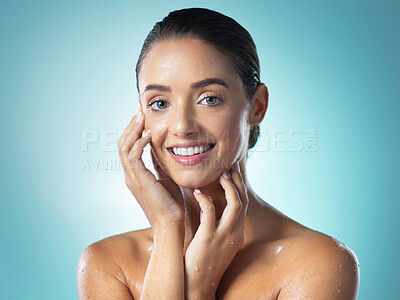 Buy stock photo Shot of a young woman taking a shower against a blue background