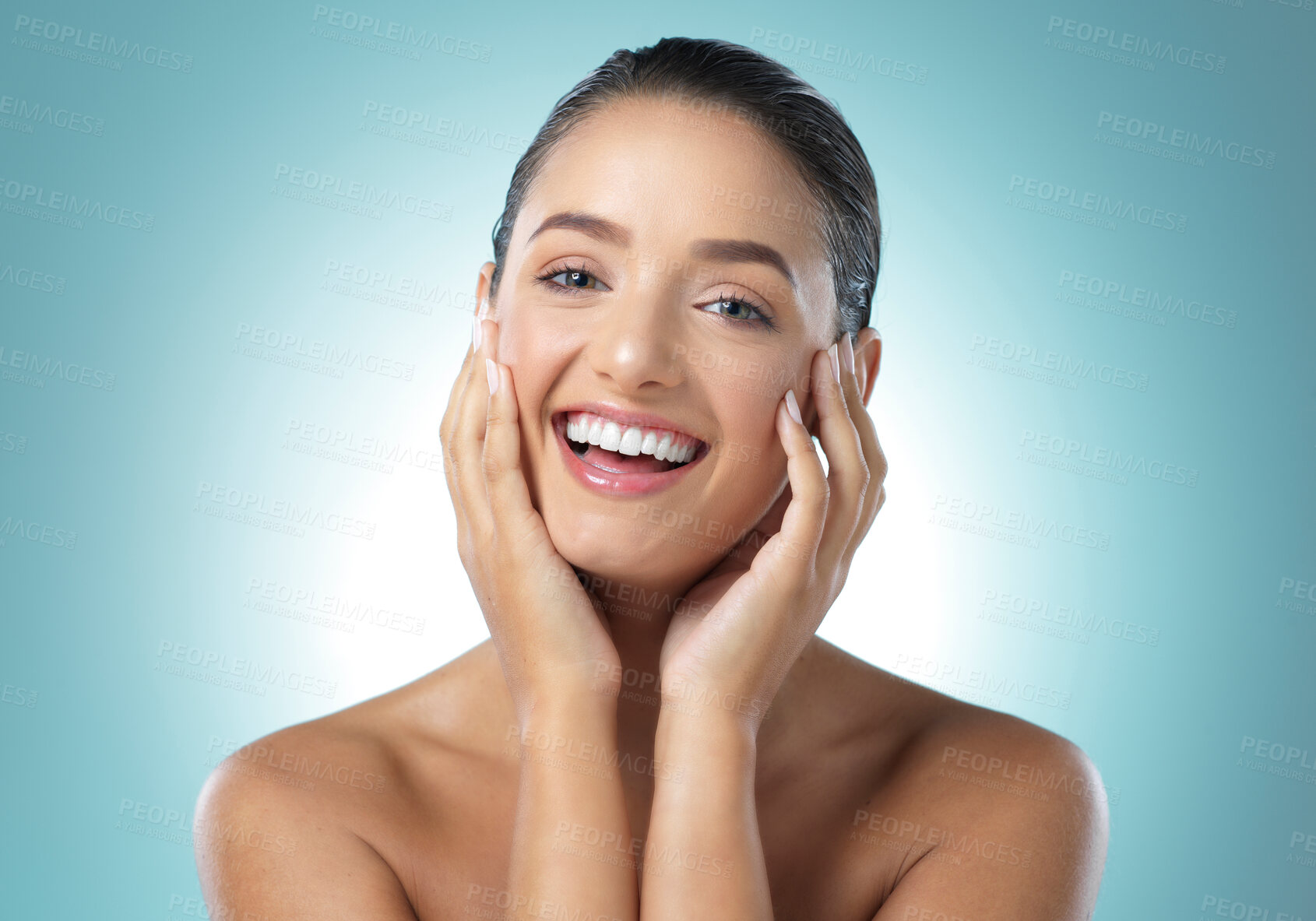 Buy stock photo Shot of a young female touching a her soft skin against a blue background