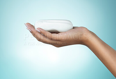 Buy stock photo Shot of an unrecognizable person using soap in the shower against a blue background