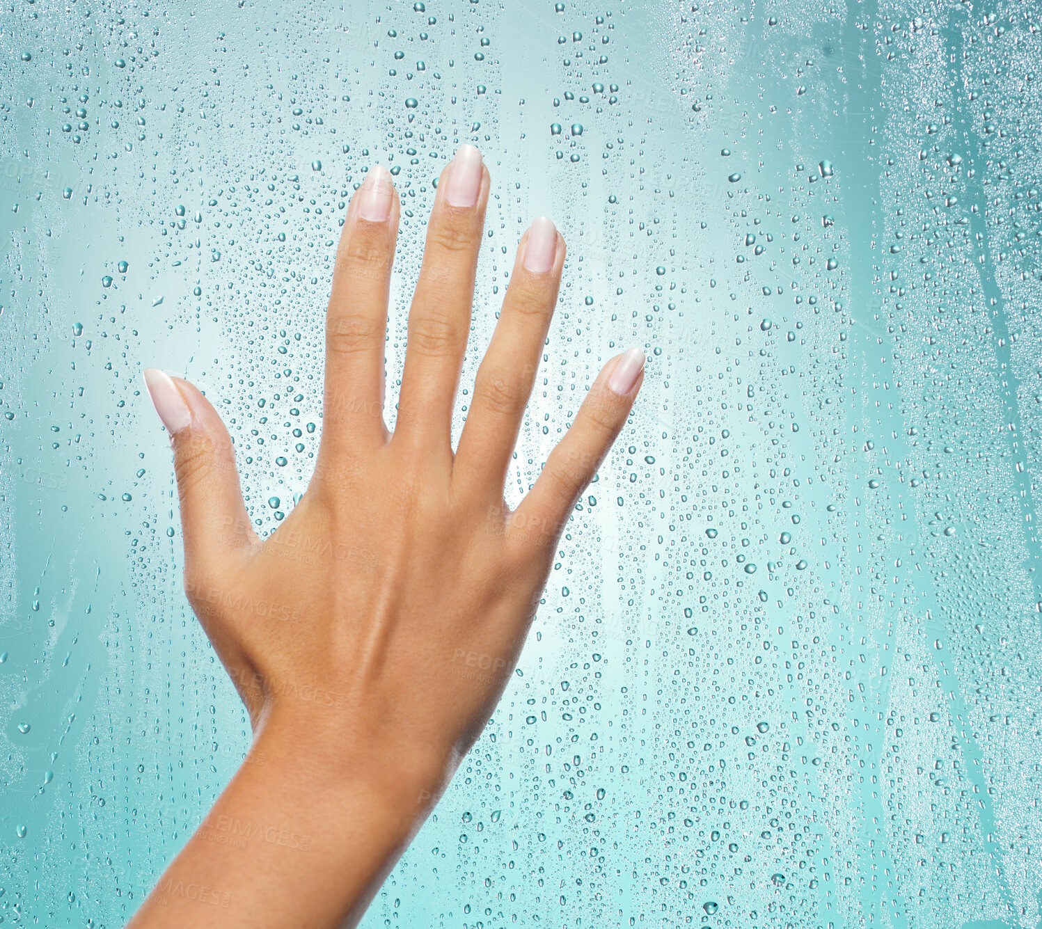 Buy stock photo Shot of a unrecognizable hand on glass against a blue background