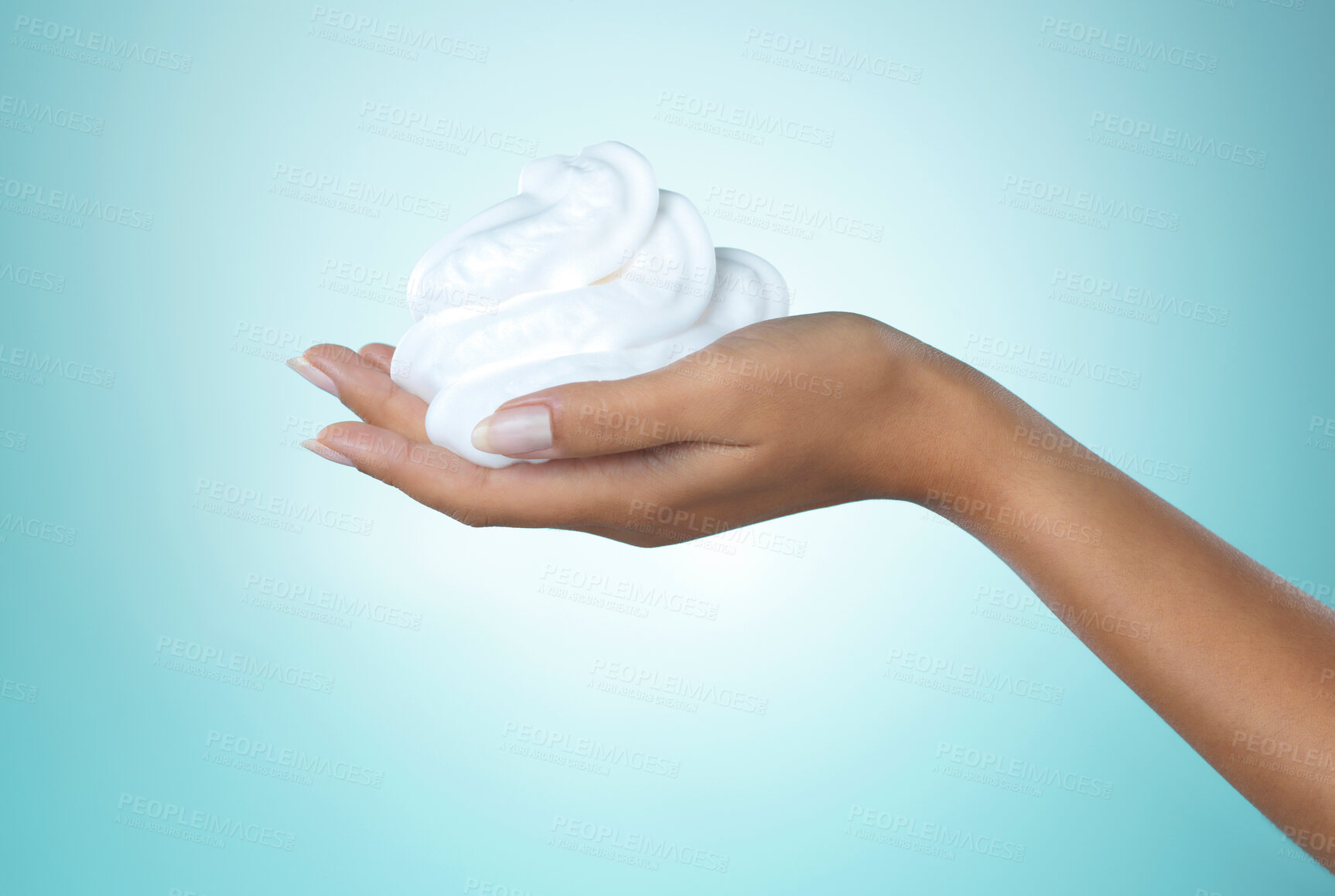 Buy stock photo Shot of an unrecognisable woman holding soap on her hand against a blue background