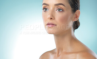 Buy stock photo Shot of a young female standing against a blue background